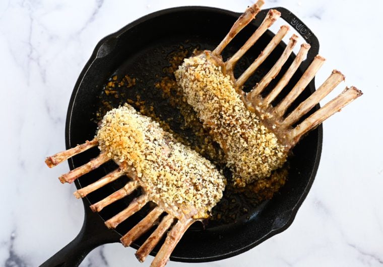 cooked rack of lamb in skillet
