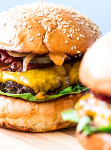 Smash burgers on a cutting board.