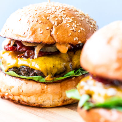 Smash burgers on a cutting board.