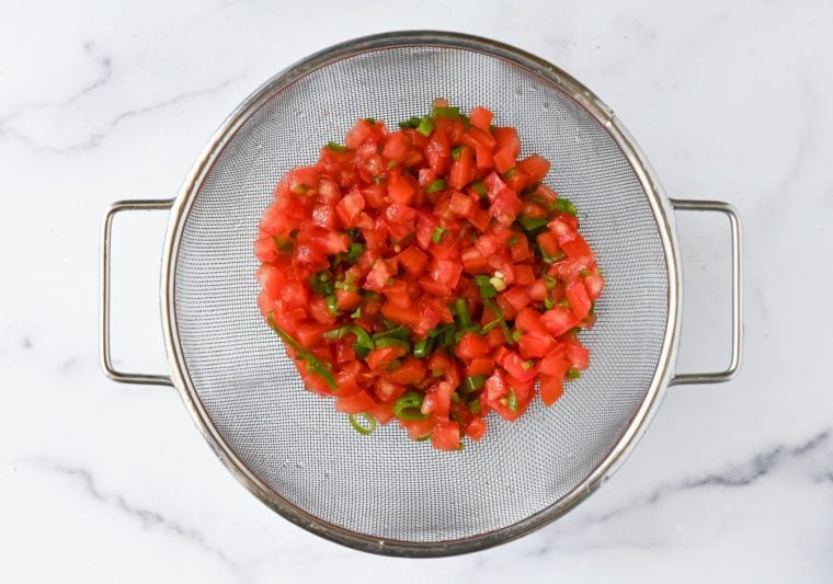 draining tomato salsa