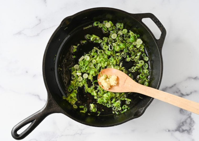 adding garlic to softened scallions