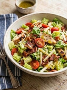BLT Salad in ceramic bowl with small bowl of vinaigrette.