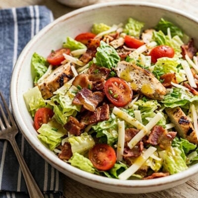 BLT Salad in ceramic bowl with small bowl of vinaigrette.