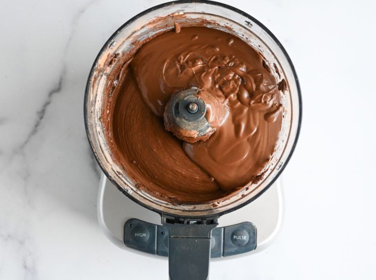 adding the melted milk chocolate to the buttercream