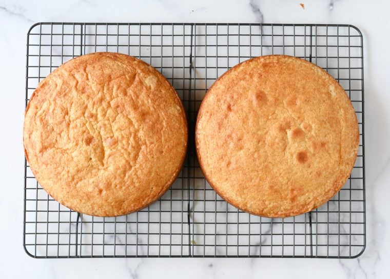 yellow cake layers cooling on rack