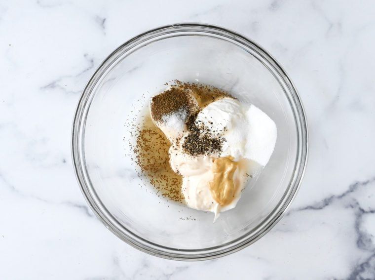 mayonnaise, sour cream, vinegar, sugar, mustard, and seasoning in mixing bowl