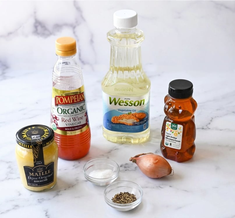 Vinaigrette ingredients including red wine vinegar, honey, and vegetable oil.