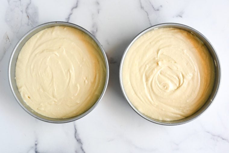 yellow cake batter in cake pans