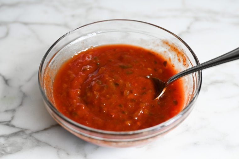 Spoon in a bowl of mixed relish.