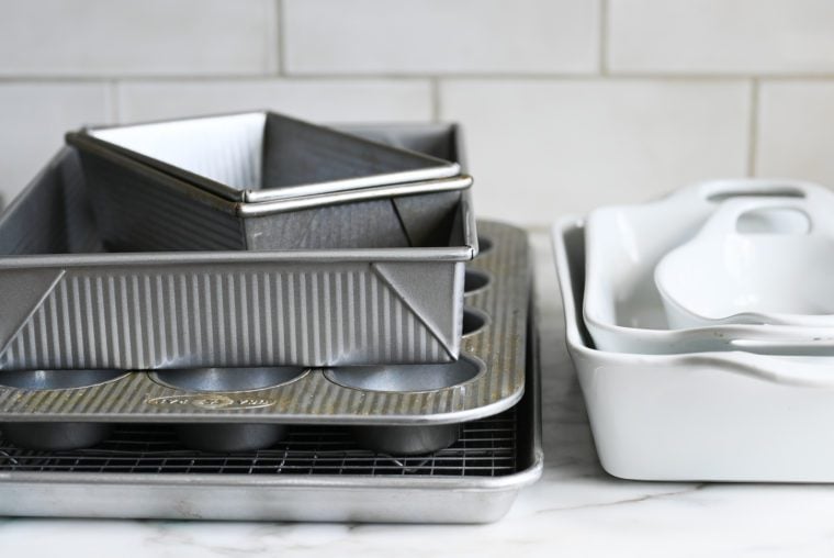 Pile of pans on a counter.
