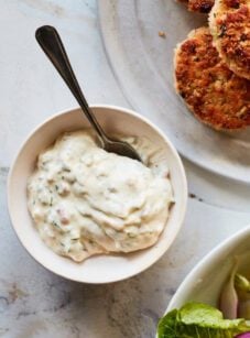 Spoon in a bowl of tartar sauce.
