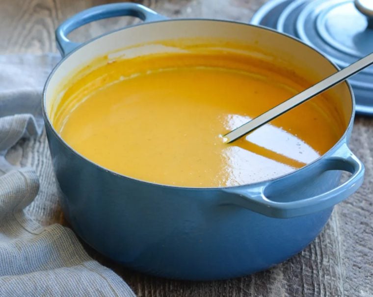 Ladle in a blue Dutch oven.