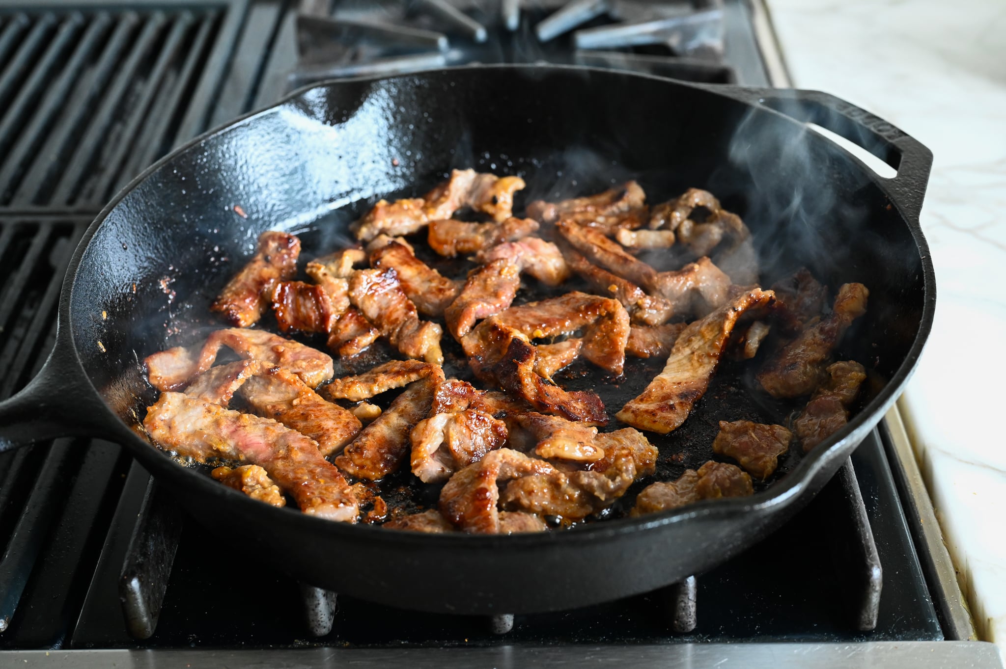 Bulgogi frying in a skillet.