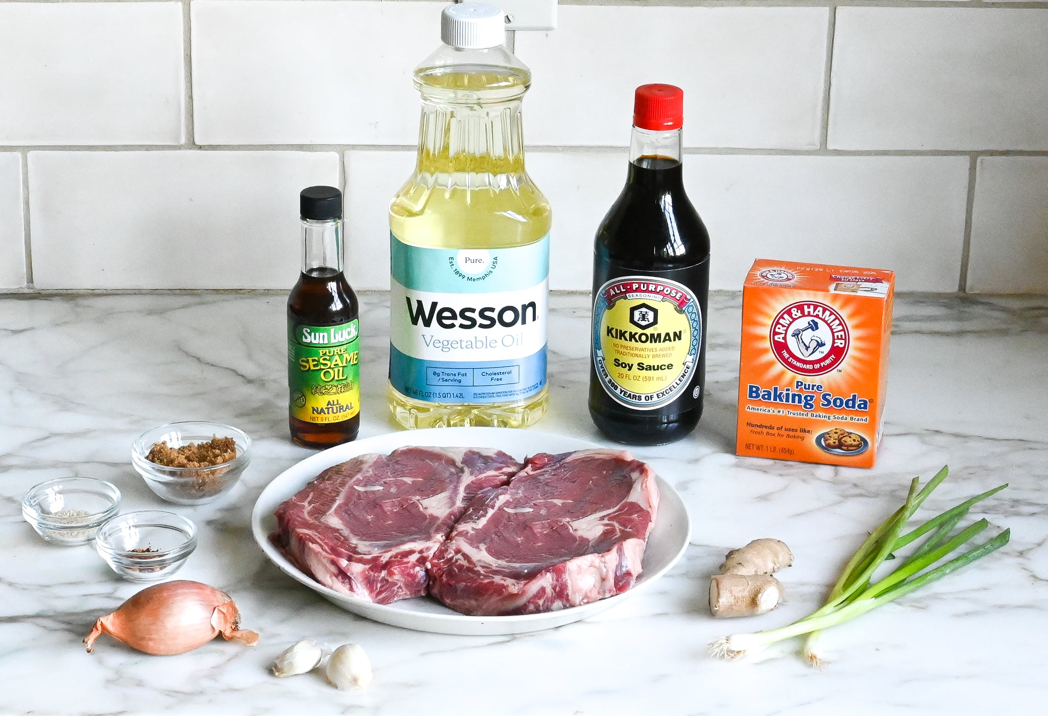 Bulgogi ingredients including soy sauce, ginger, and garlic on the counter.