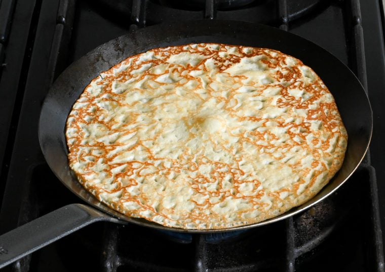 flipped crepe cooking on second side.