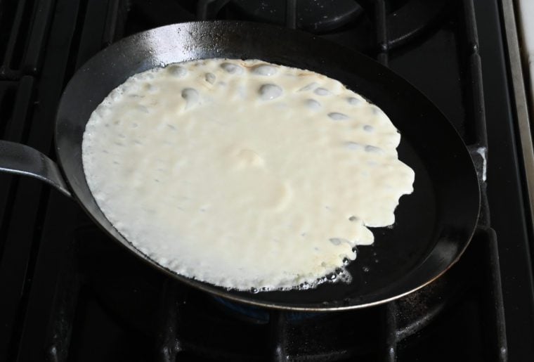 swirling the crepe batter around the pan.