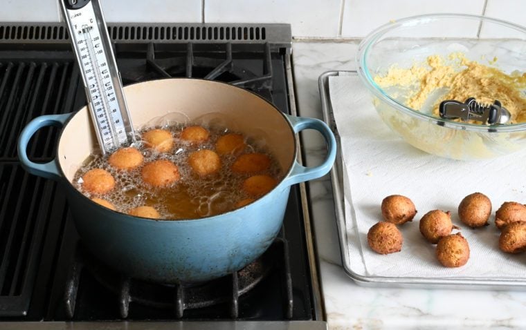 golden brown hush puppies in dutch oven
