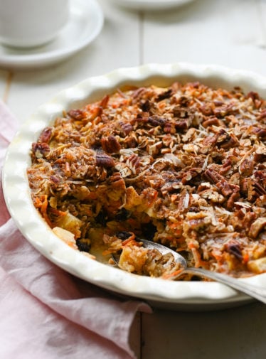 Spoon in a partially-served dish of baked oatmeal.