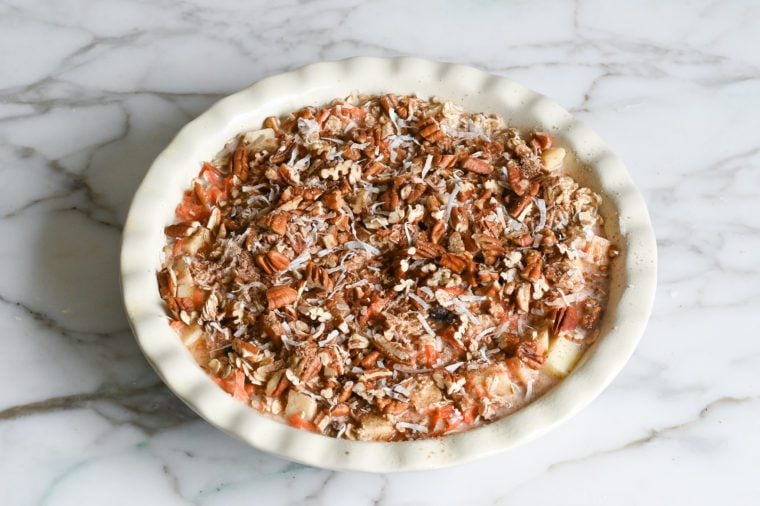 sprinkling topping over oat mixture