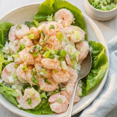 Shrimp salad in bowl with butter lettuce leaves.