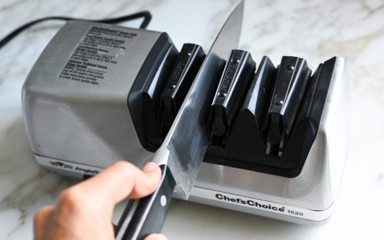 Person using a knife sharpener.