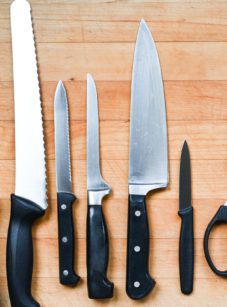 Knives and cutting tools on a cutting board.
