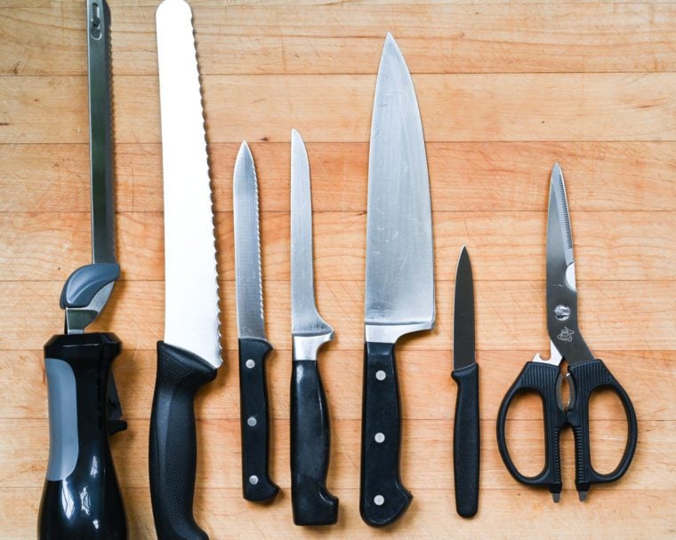 Knives and cutting tools on a cutting board.