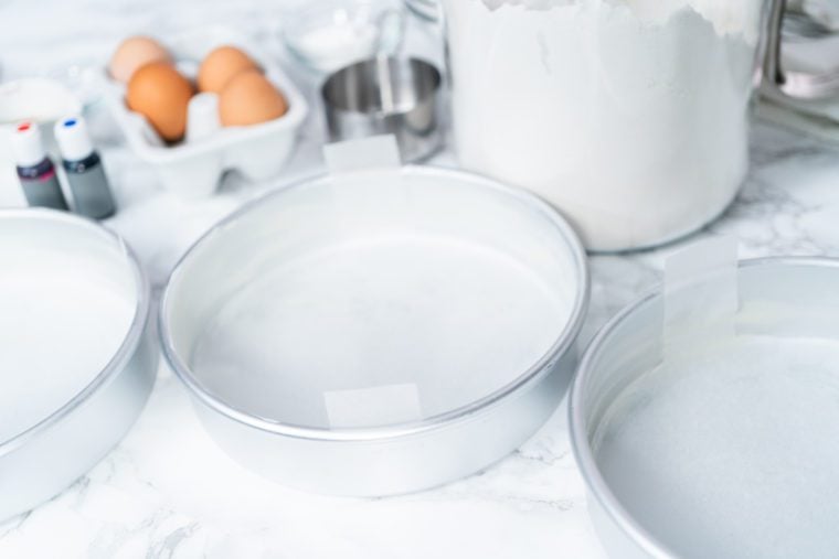 Pans with eggs and flour on a countertop.