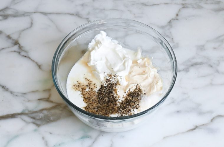 mayonnaise, sour cream, buttermilk, salt, pepper, garlic, and apple cider vinegar in bowl