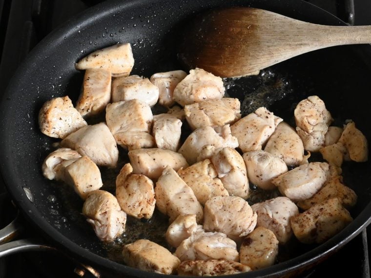 cooked chicken pieces in skillet