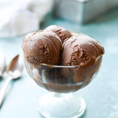 Three scoops of chocolate ice cream in a stemmed glass.