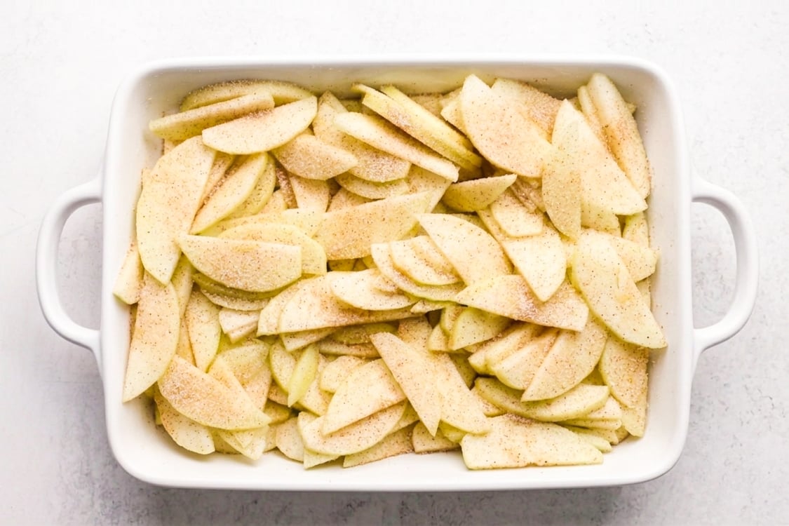 Apple slices layered in baking dish
