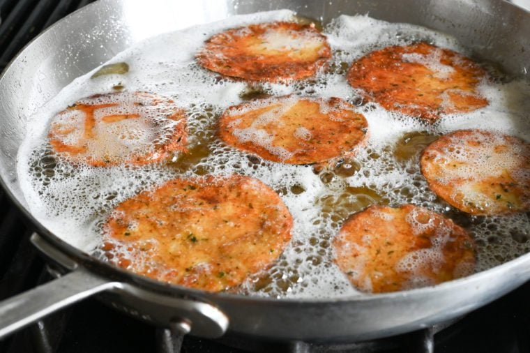 golden brown eggplant slices in oil