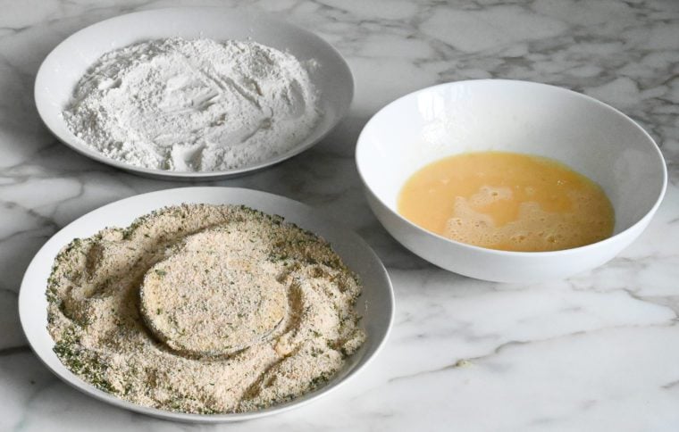 dredging eggplant slice in breadcrumbs