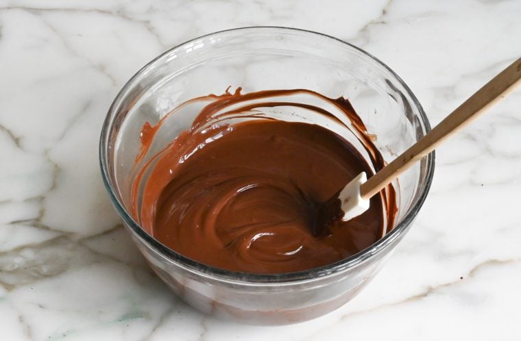 Glass bowl of melted chocolate.