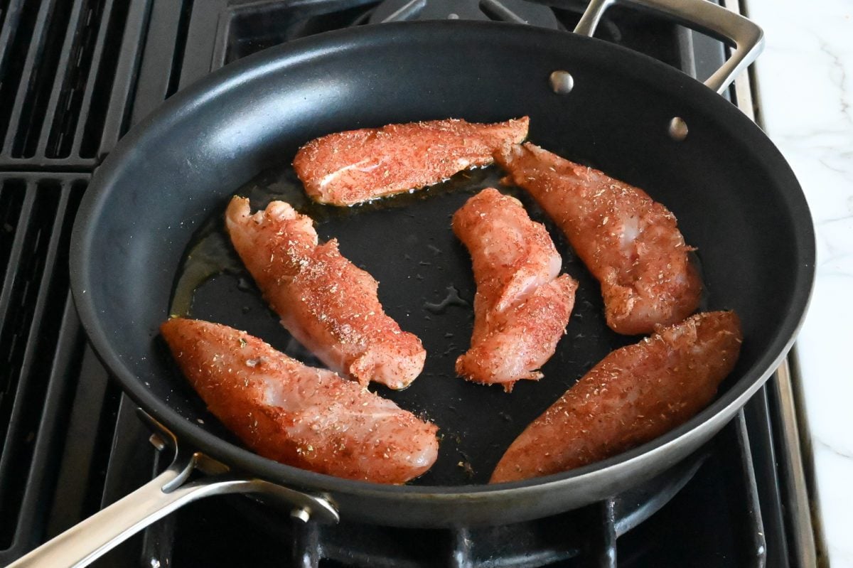 cooking chicken on first side in skillet