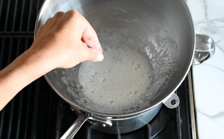 rubbing egg white mixture between fingers to see if it's ready 