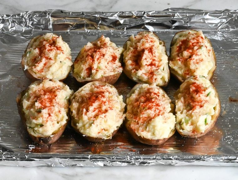 potato mixture spooned into scooped potato skins