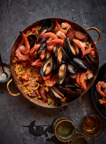 Spanish paella in beautiful copper paella pan.
