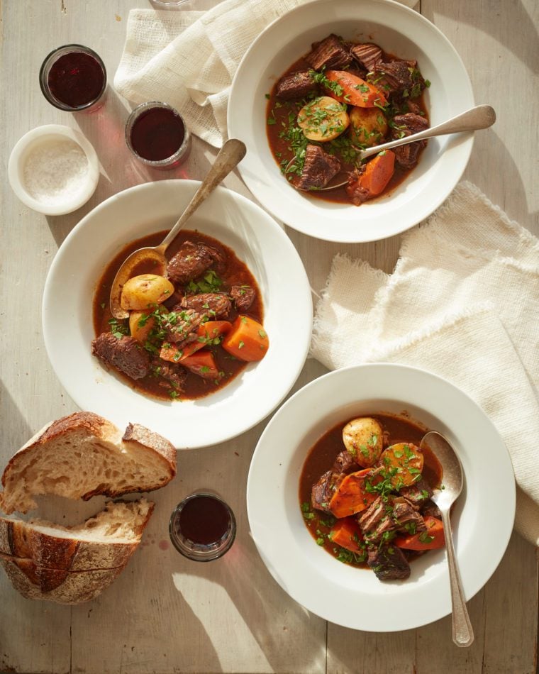 Three bowls of stew on a table.