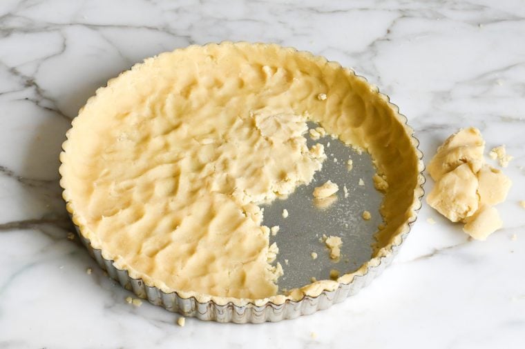 pressing the crust in the tart pan