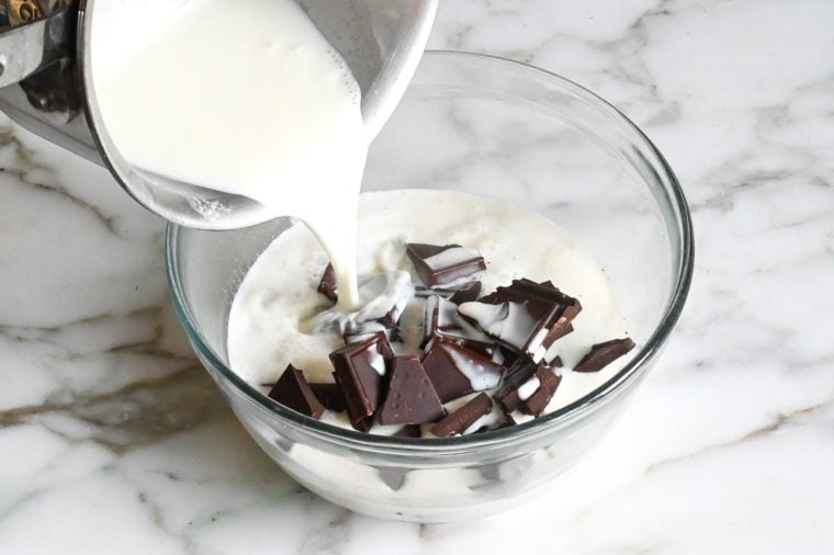 adding hot cream to chocolate