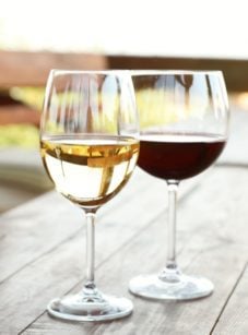 Glass of red wine next to a glass of white wine.