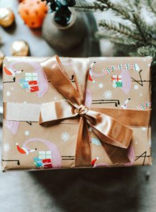 Wrapped present with a bronze-colored ribbon.