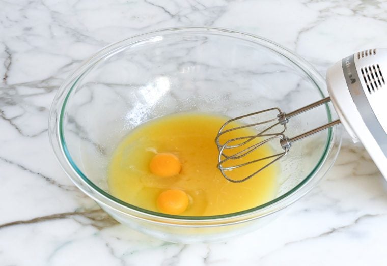 adding the eggs, vanilla, and almond extracts