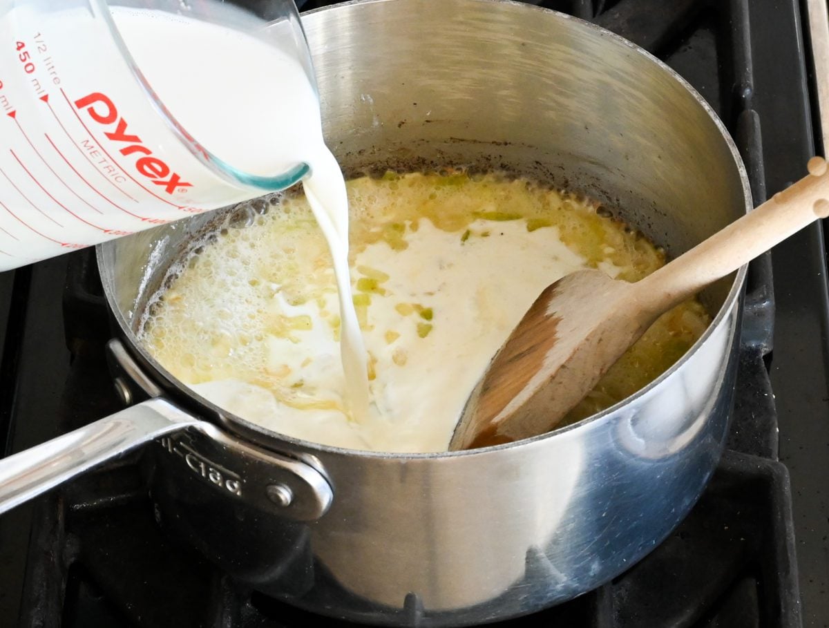 pouring half & half into pot.