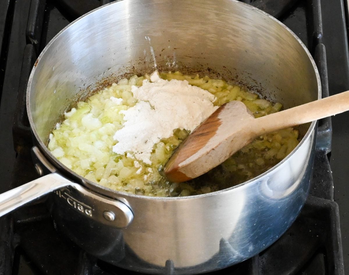 adding the flour to the onion mixture.
