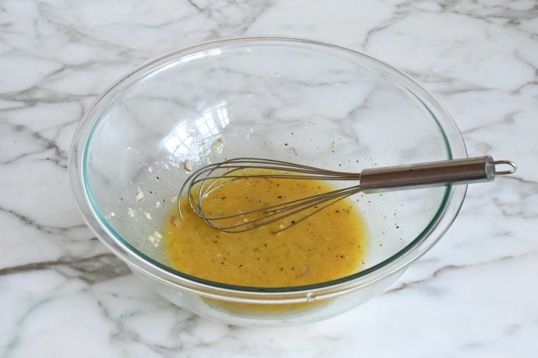 Whisked honey-dijon vinaigrette in a bowl.