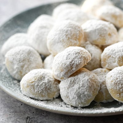 Snowball cookies piled on a plate.
