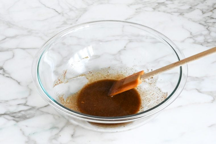 spiced nuts coating mixed in bowl